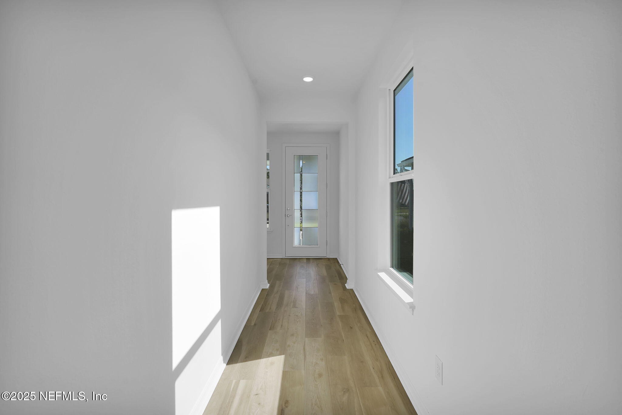 239 Fairlake Circle St. Augustine, FL 32092 - Photo 6 of 30 a view of a hallway with wooden floor