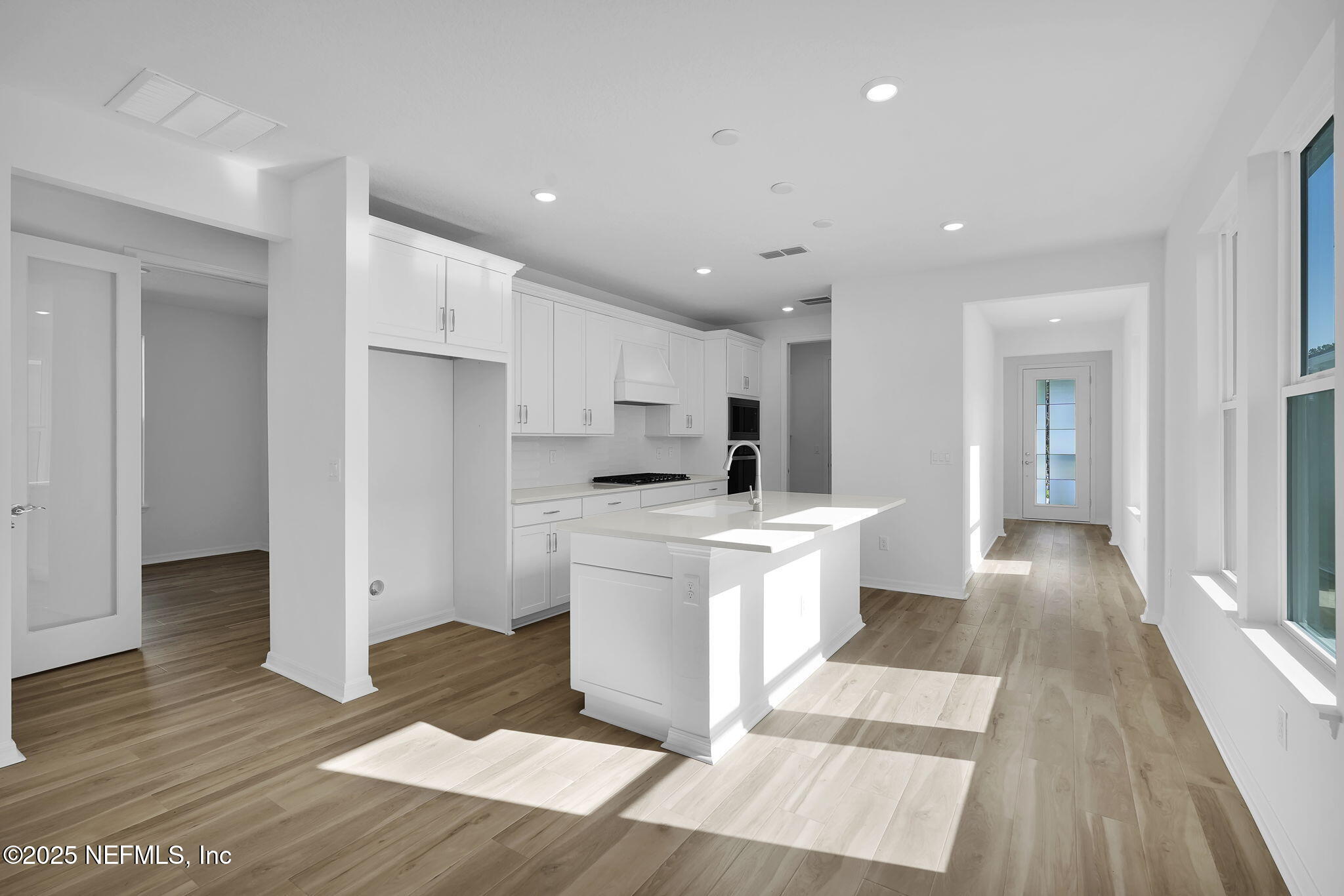 239 Fairlake Circle St. Augustine, FL 32092 - Photo 8 of 30 a large kitchen with stainless steel appliances kitchen island a large counter top and a wooden floors