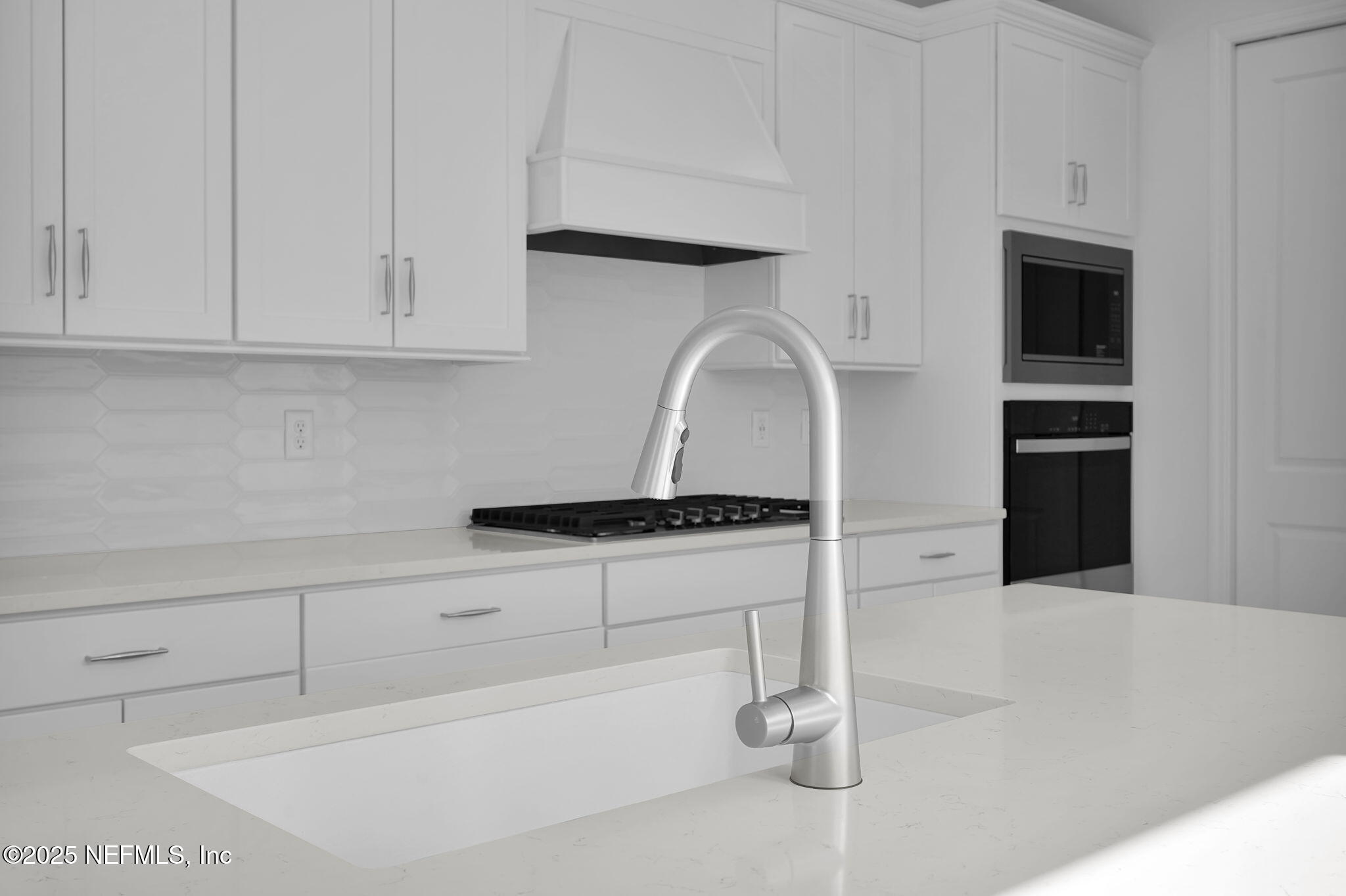 239 Fairlake Circle St. Augustine, FL 32092 - Photo 9 of 30 a kitchen with white cabinets and appliances