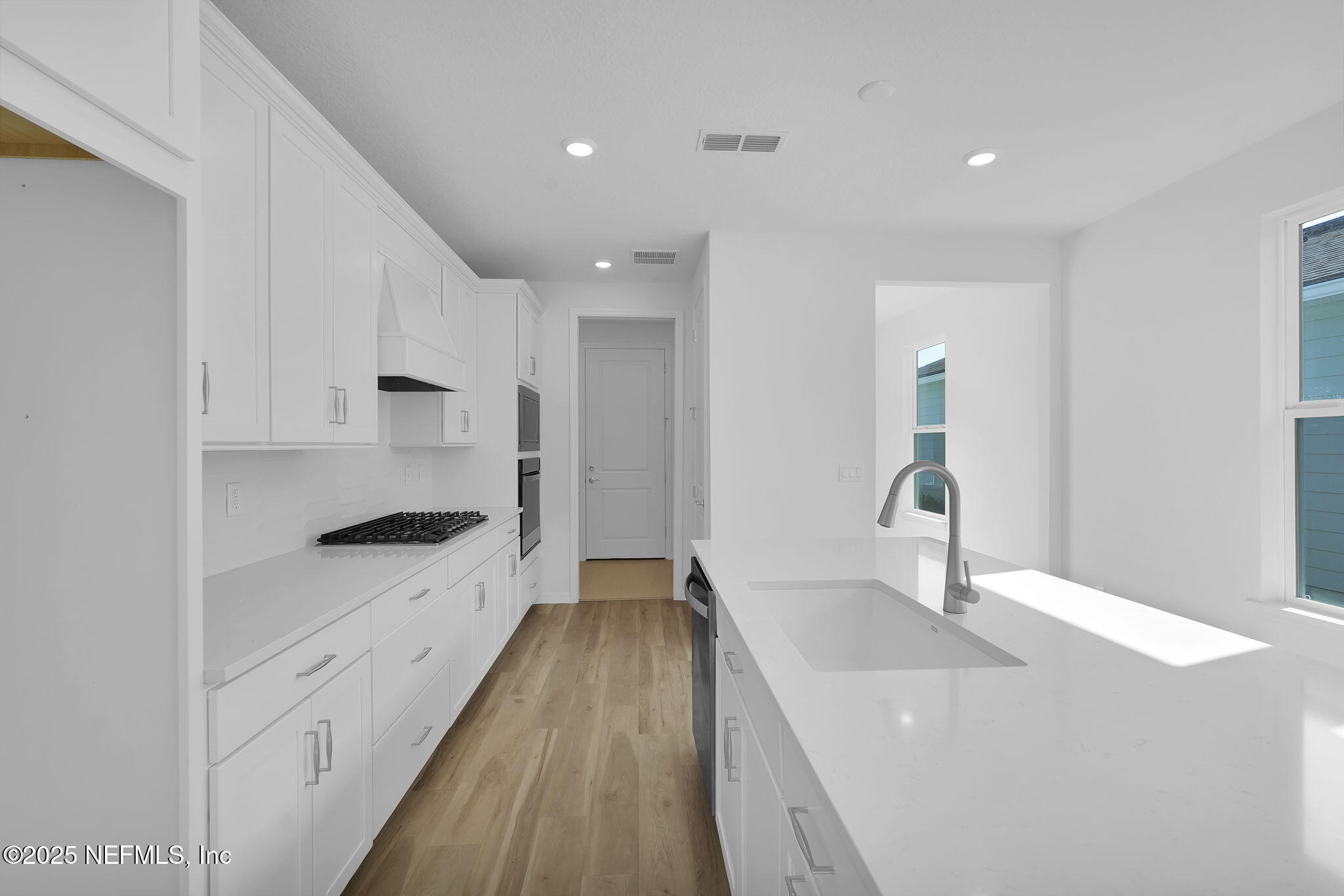 239 Fairlake Circle St. Augustine, FL 32092 - Photo 10 of 30 a kitchen with granite countertop a sink and cabinets