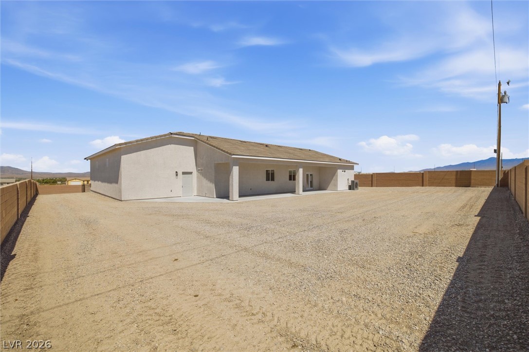1061 Factory Road Pahrump, NV 89048 - Photo 35 of 41 A spacious, gravel-filled lot surrounds this contemporary desert home, offering ample room for outdoor activities.
