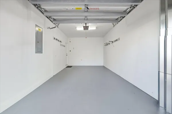 an empty room with a ceiling fan and wooden floor