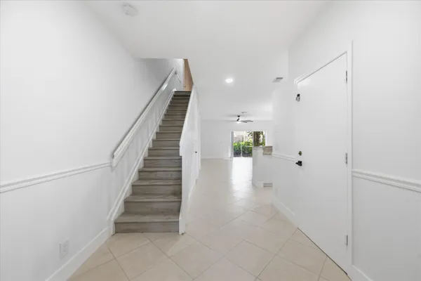 a view of entryway and hall with wooden floor
