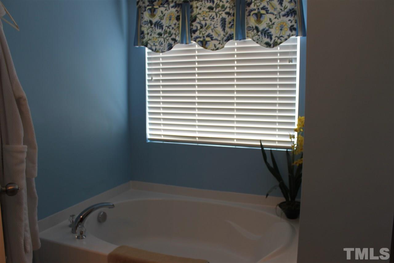 3108 Varcroft Road Knightdale, NC 27545 - Photo 14 of 17 a bathroom with a bathtub and a window