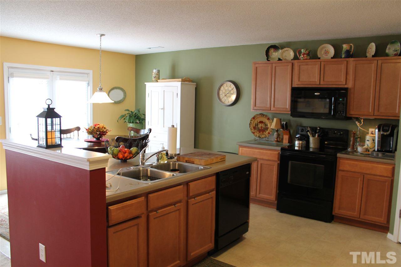 3108 Varcroft Road Knightdale, NC 27545 - Photo 4 of 17 a kitchen with stainless steel appliances granite countertop a sink stove and cabinets