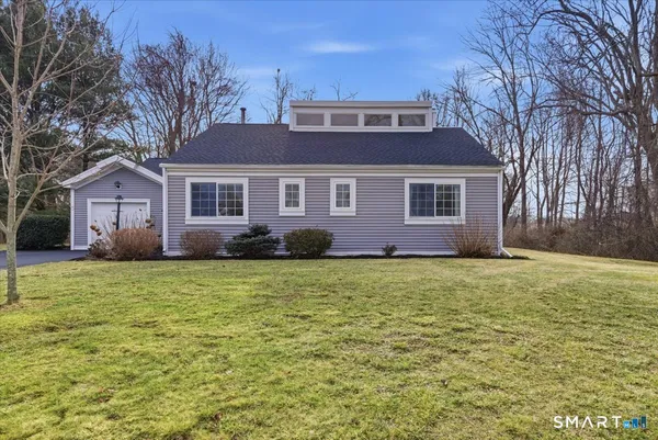 a front view of a house with a garden