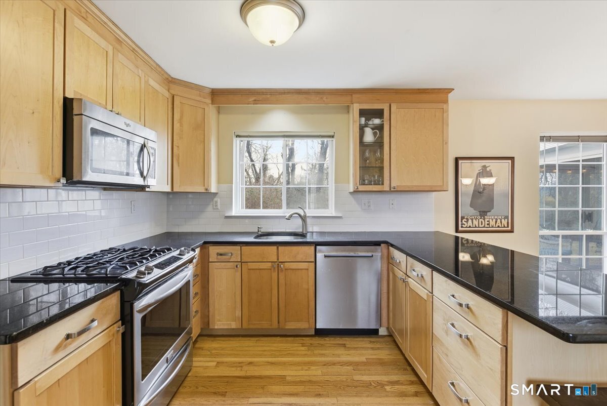 367 Main Street, Unit 7 Old Saybrook, CT 06475 - Photo 12 of 27 a kitchen with stainless steel appliances granite countertop a stove a sink and a microwave