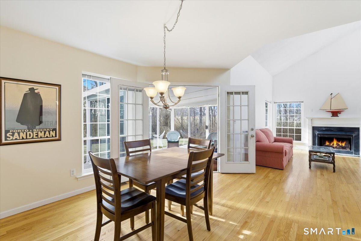 367 Main Street, Unit 7 Old Saybrook, CT 06475 - Photo 13 of 27 a dining room with furniture a chandelier and wooden floor