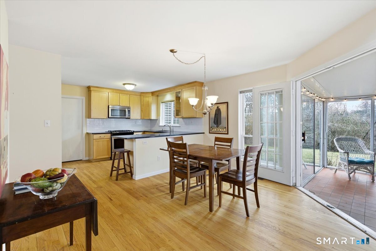 367 Main Street, Unit 7 Old Saybrook, CT 06475 - Photo 14 of 27 a view of a dining room with furniture and wooden floor