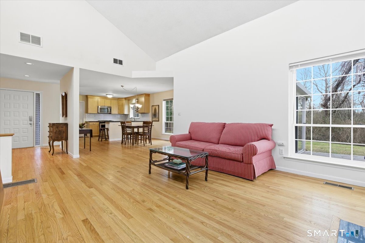 367 Main Street, Unit 7 Old Saybrook, CT 06475 - Photo 16 of 27 a living room with furniture and a wooden floor