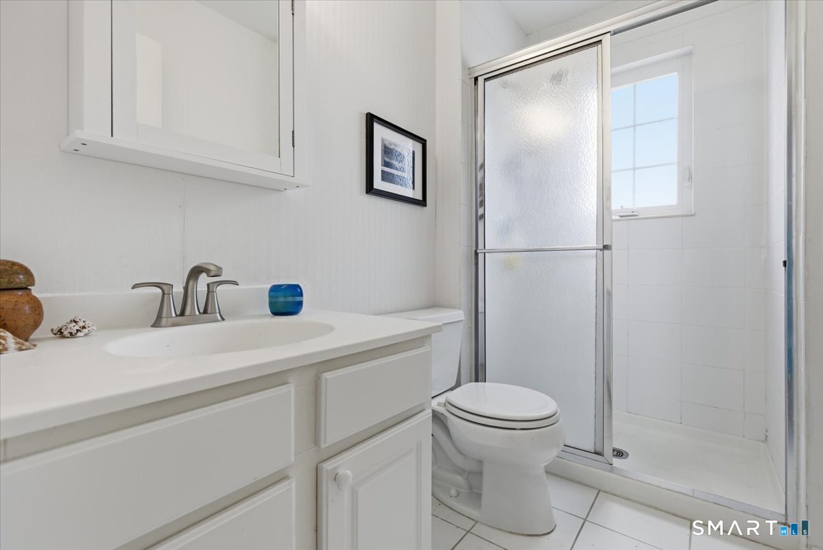 367 Main Street, Unit 7 Old Saybrook, CT 06475 - Photo 19 of 27 a bathroom with a sink a toilet and a shower