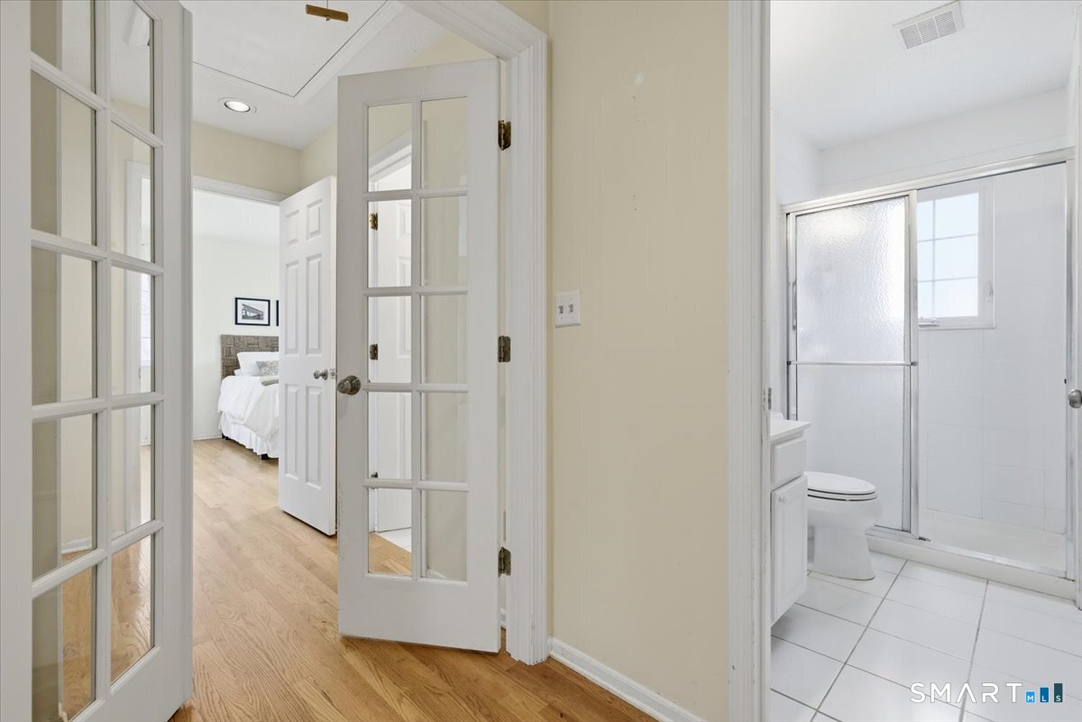 367 Main Street, Unit 7 Old Saybrook, CT 06475 - Photo 20 of 27 a bathroom with a glass shower door and a toilet