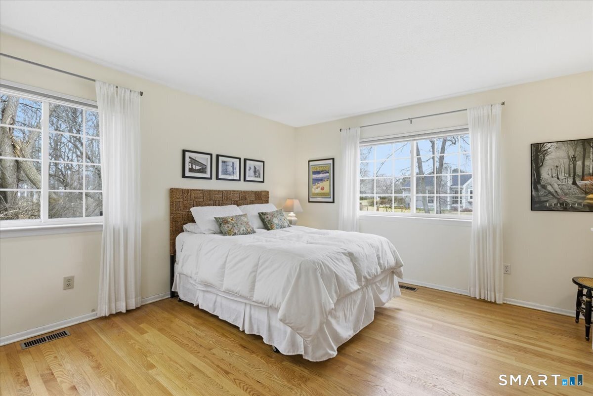 367 Main Street, Unit 7 Old Saybrook, CT 06475 - Photo 22 of 27 a bedroom with a bed and a window