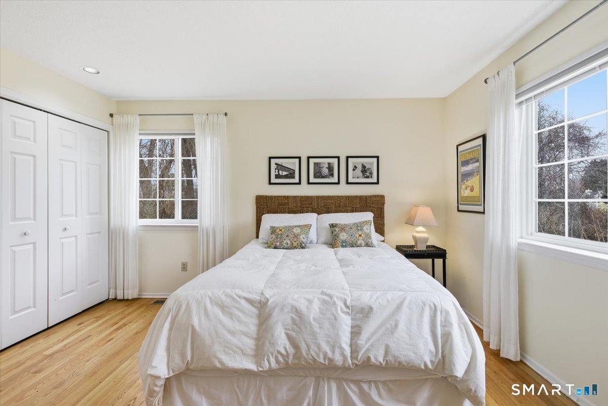 367 Main Street, Unit 7 Old Saybrook, CT 06475 - Photo 23 of 27 a bedroom with a bed and a window