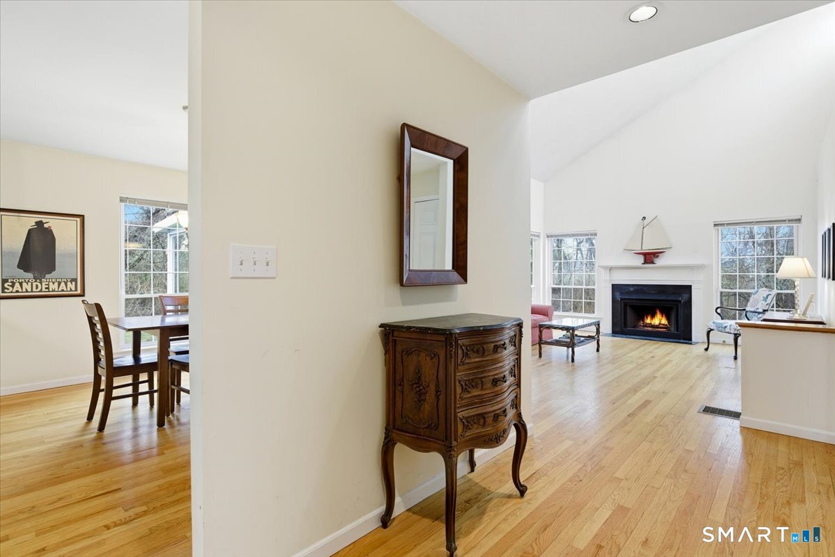 367 Main Street, Unit 7 Old Saybrook, CT 06475 - Photo 7 of 27 a living room with furniture a fireplace and a table