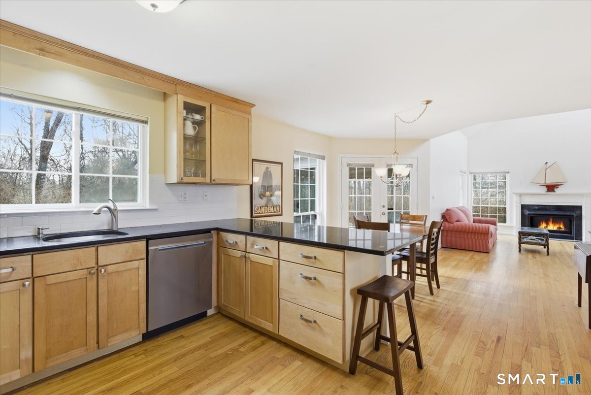 367 Main Street, Unit 7 Old Saybrook, CT 06475 - Photo 8 of 27 a open kitchen with cabinets a sink and chairs in it