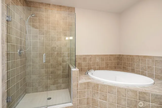 a bathroom with a bathtub and a shower