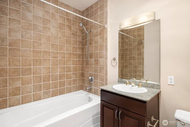 a bathroom with a sink shower and a bathtub