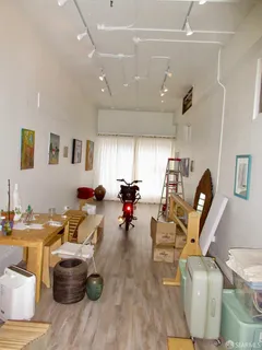 a living room with lots of furniture and a view of kitchen
