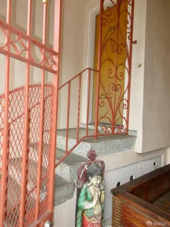 a bedroom with a bed and a chair