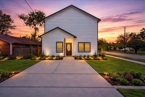 a front view of house with yard and green space