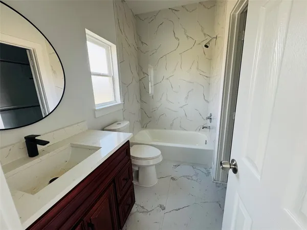 a bathroom with a sink a toilet and a mirror