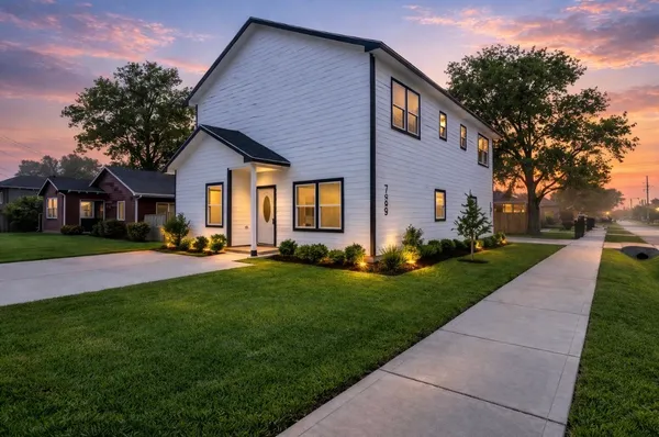 a front view of house with yard and green space