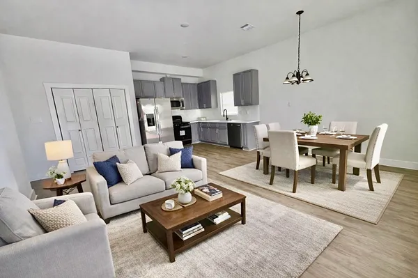 a living room with furniture a rug and a chandelier