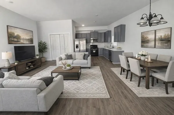 a living room with furniture kitchen view and a flat screen tv