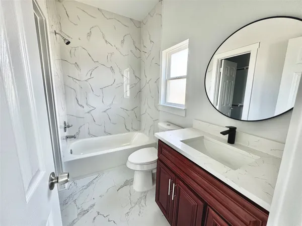 a bathroom with a sink a toilet and bathtub
