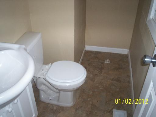 132 Kingston Road Bolingbrook, IL 60440 - Photo 7 of 9 a white toilet sitting next to a shower
