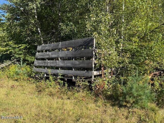 0 Daniels Road North Adams, MA 01247 - Photo 21 of 26 a wooden bench sitting in the middle of a forest