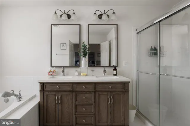 a bathroom with a double vanity sink mirror and double