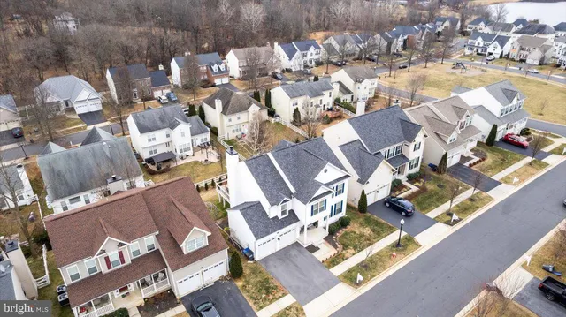an aerial view of multiple houses with a yard