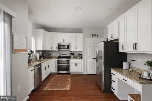 a kitchen with stainless steel appliances a refrigerator sink and cabinets