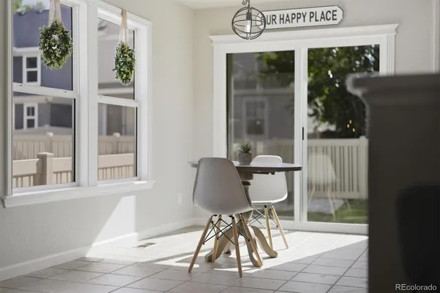 a table and chair in a room with a window