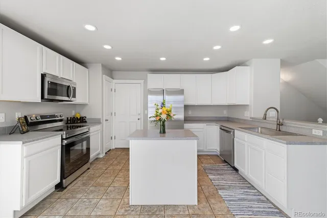 a kitchen with a sink stainless steel appliances and cabinets