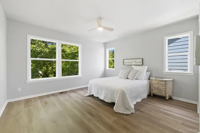 a bedroom with a bed and wooden floor
