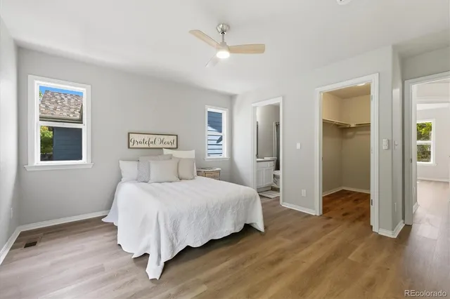 a bedroom with a bed and a ceiling fan