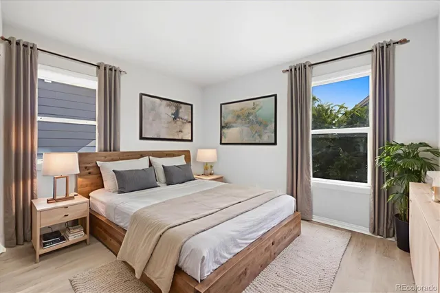 a bedroom with a large bed and a large window