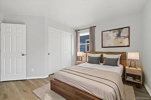 a bedroom with a bed and a painting on the wall