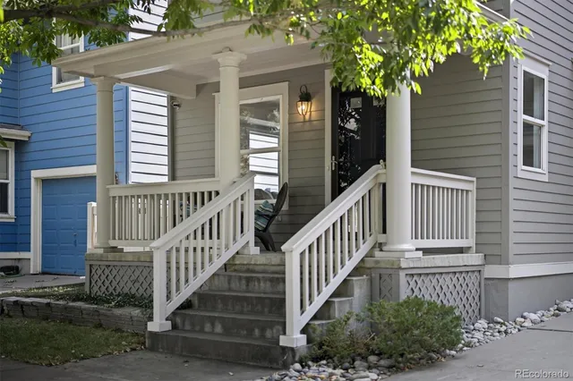 a view of a house with a small yard and wooden fence