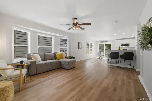 a living room with furniture and a wooden floor