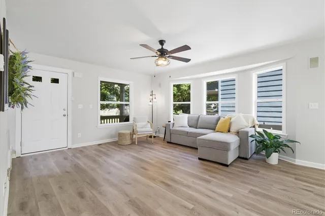 a living room with furniture and wooden floor