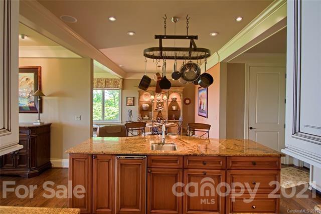 851 Sunlight Ridge Drive Hendersonville, NC 28792 - Photo 2 of 6 a kitchen with a sink and chandelier