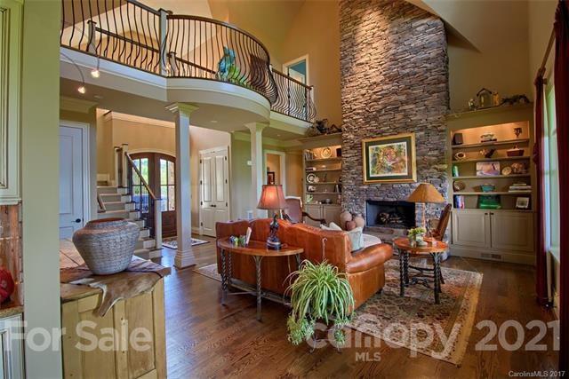 851 Sunlight Ridge Drive Hendersonville, NC 28792 - Photo 4 of 6 a living room with fireplace furniture and a wooden floor