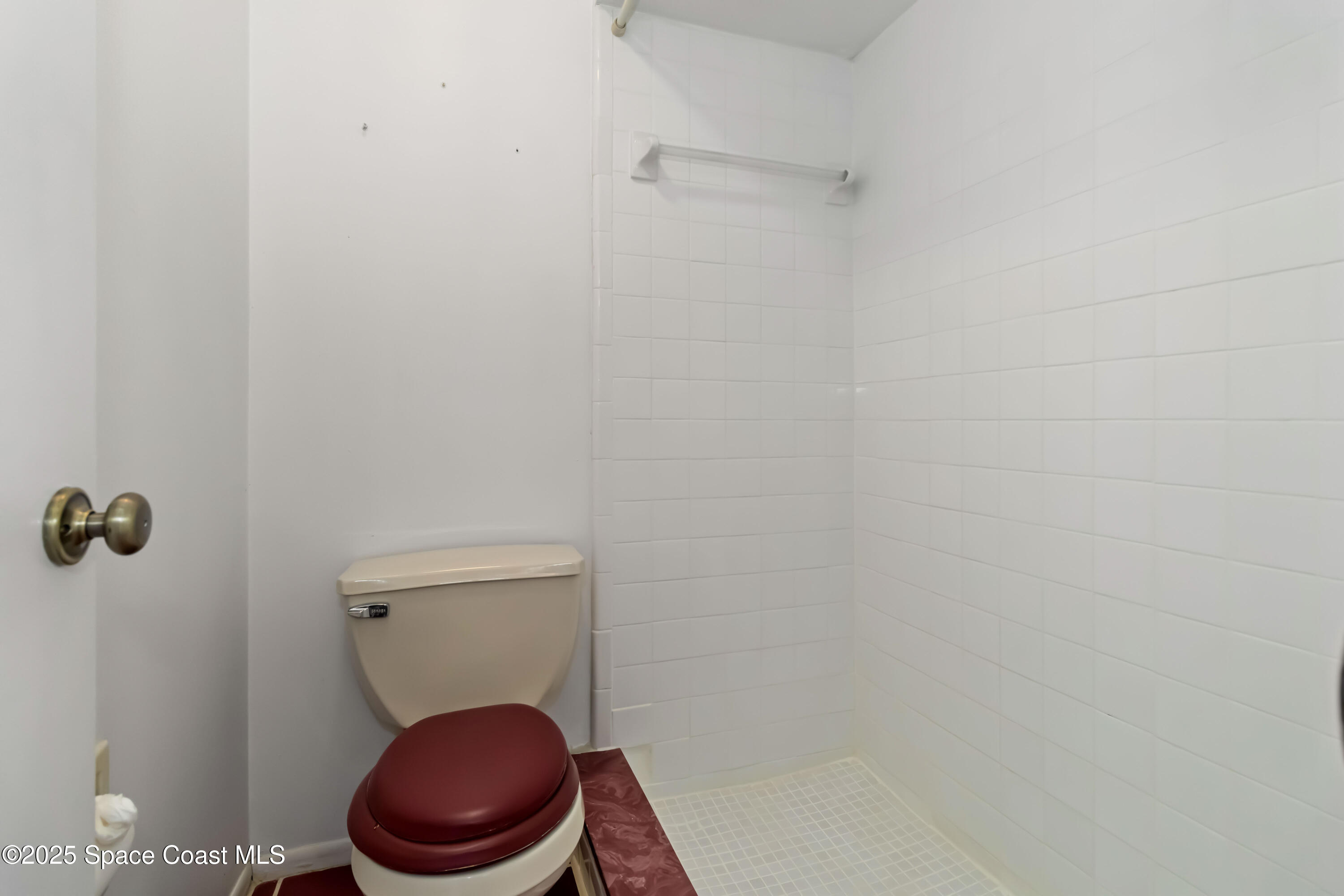 3728 West Malory Court Cocoa, FL 32926 - Photo 13 of 17 a white toilet sitting in a bathroom and a sink