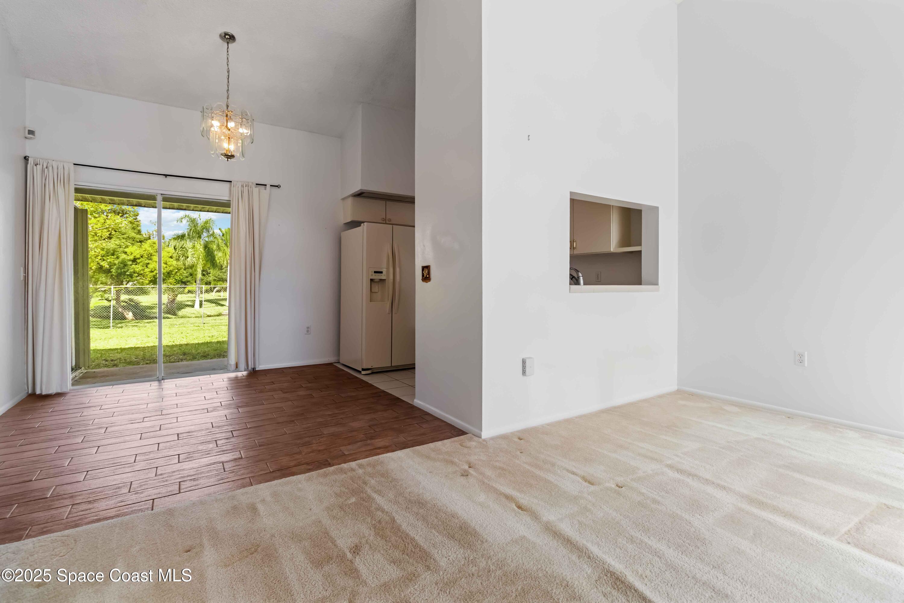 3728 West Malory Court Cocoa, FL 32926 - Photo 15 of 37 a view of an empty room with wooden floor and a window