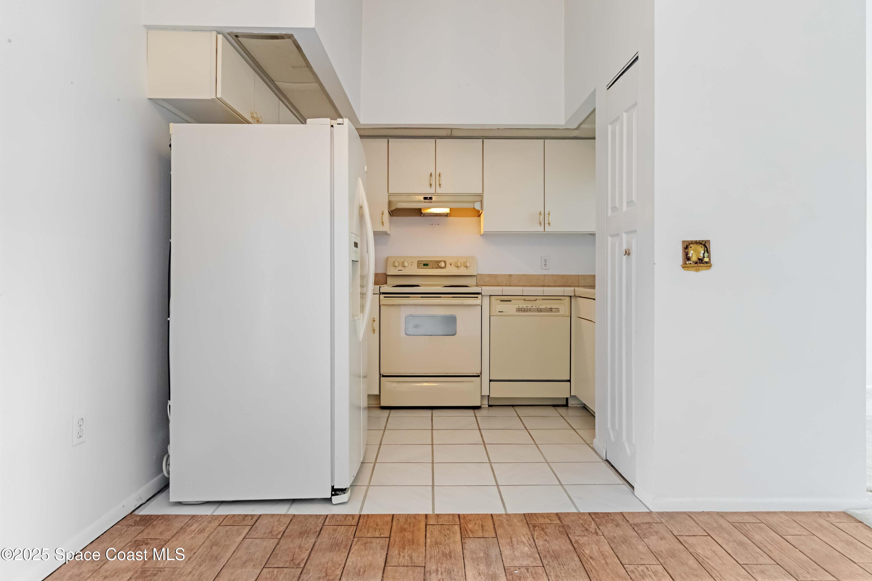 3728 West Malory Court Cocoa, FL 32926 - Photo 19 of 37 a kitchen with a white cabinets and white appliances
