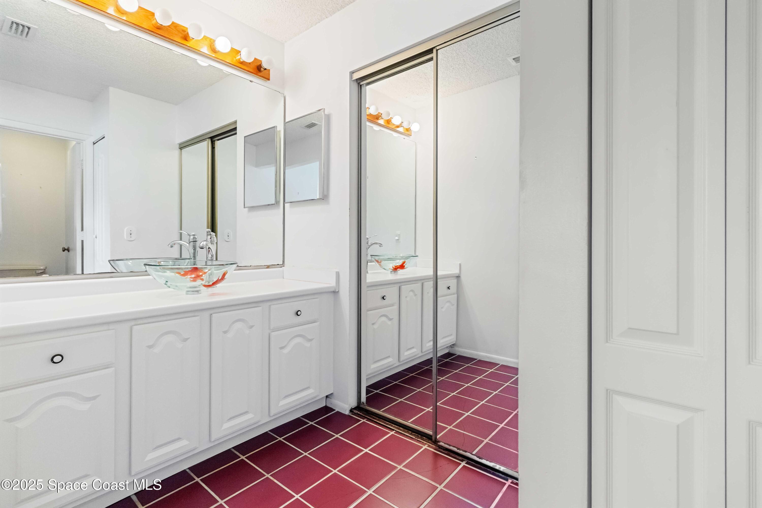 3728 West Malory Court Cocoa, FL 32926 - Photo 26 of 37 a spacious bathroom with a double vanity sink a mirror and a shower